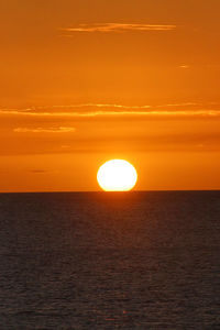 Scenic view of sea against romantic sky at sunset