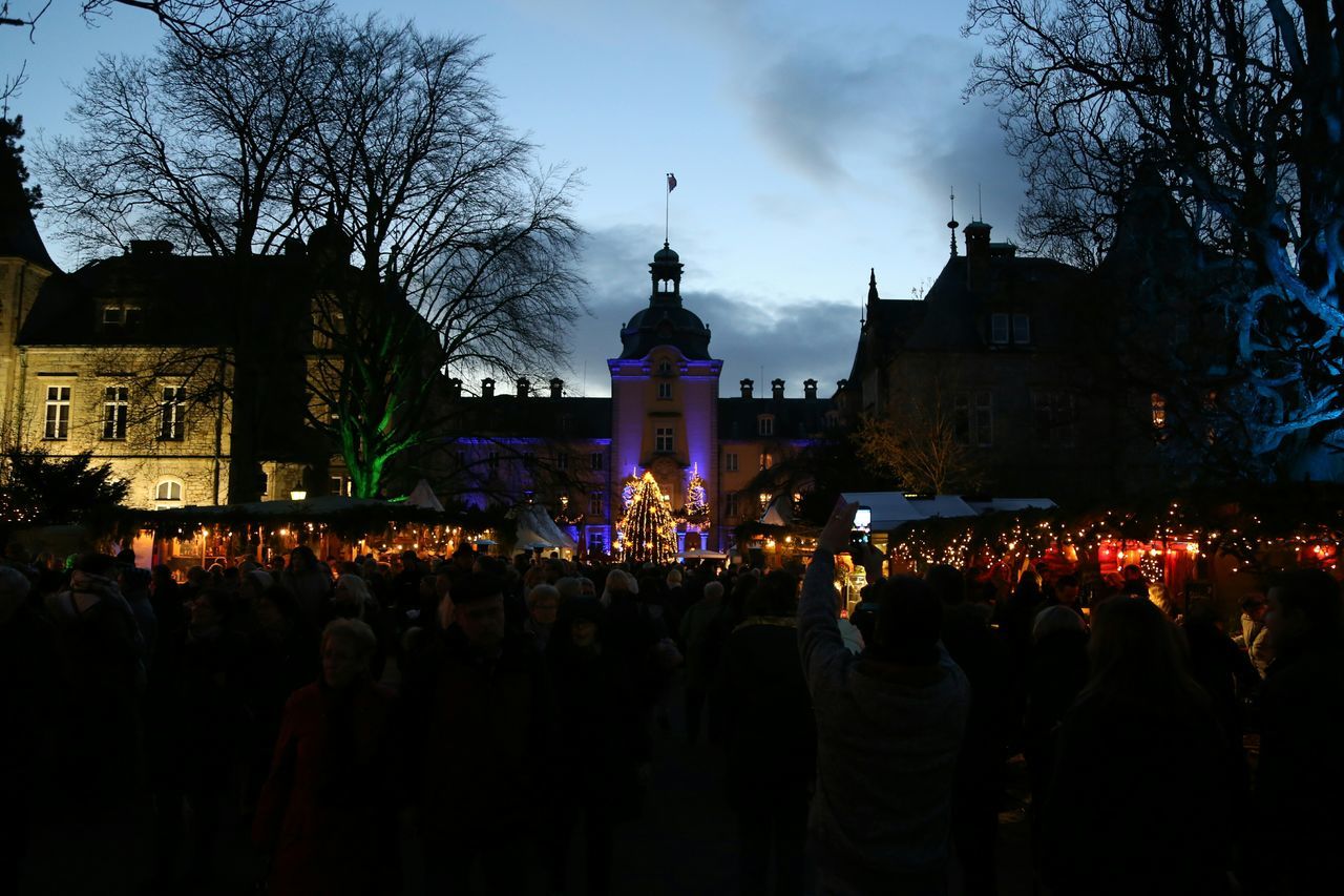 large group of people, illuminated, night, crowd, lifestyles, men, person, leisure activity, sky, building exterior, celebration, built structure, architecture, dusk, lighting equipment, silhouette, togetherness, enjoyment, mixed age range