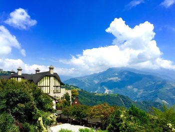 Panoramic shot of building and mountains against sky