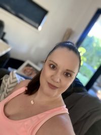 Portrait of a smiling young woman sitting at home