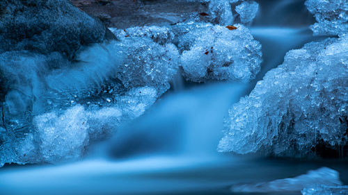 Long exposure of a beautiful frozen forest stream.