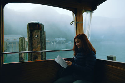 Woman sitting in boat on lake