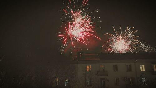 Low angle view of firework display in sky at night