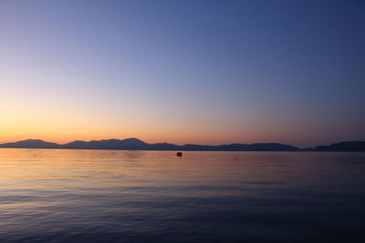 Scenic view of sea against clear sky during sunset