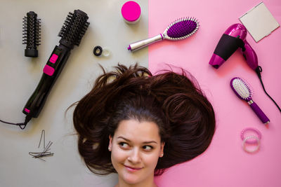 Woman with brown hair by personal accessories on table