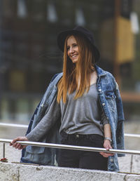 Portrait of smiling young woman standing outdoors