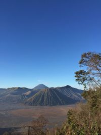 Scenic view of landscape against blue sky