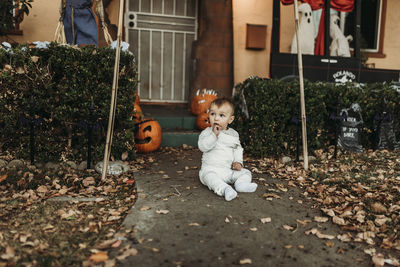 Adorable toddler boy dressed up as mummy on halloween trick-or-treat