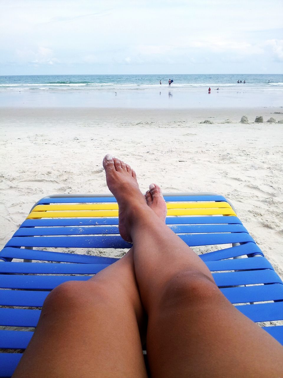 sea, person, low section, personal perspective, beach, horizon over water, barefoot, water, relaxation, sand, lifestyles, leisure activity, vacations, shore, human foot, legs crossed at ankle