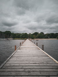 Pier over lake against sky