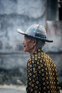 Side view portrait of a man against blurred background
