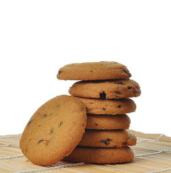 Close-up of stack on table against white background