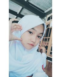 Portrait of boy holding window