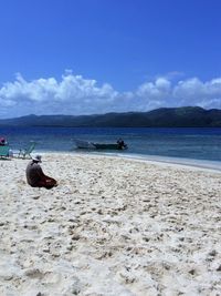 Scenic view of beach against blue sky