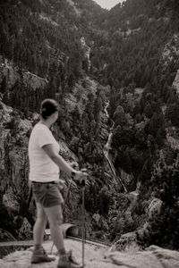 Rear view of man standing on mountain