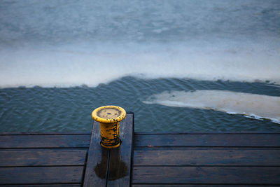 High angle view of railing by sea against sky