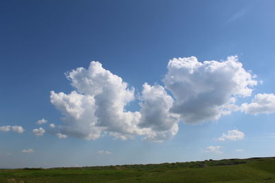 Scenic view of landscape against blue sky