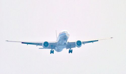 Low angle view of airplane flying against clear sky
