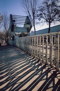 Empty footpath by building against sky