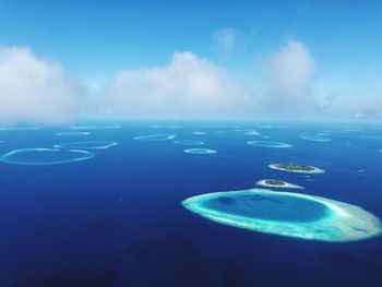 Aerial view of sea against blue sky