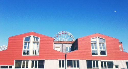 Low angle view of built structure against clear blue sky