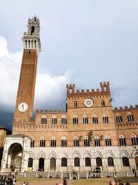 Low angle view of clock tower against sky