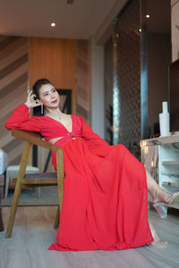 Portrait of young woman sitting on chair