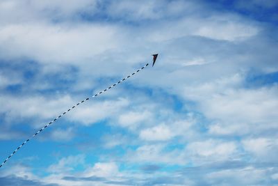 Low angle view of birds flying against sky