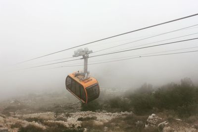 Overhead cable car during foggy weather
