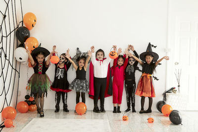 Group of people standing against wall during halloween