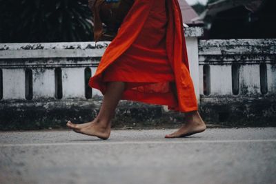 Low section of person walking on street