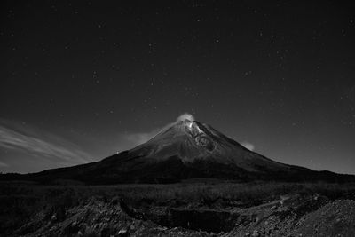 Scenic view of mountains against sky at night