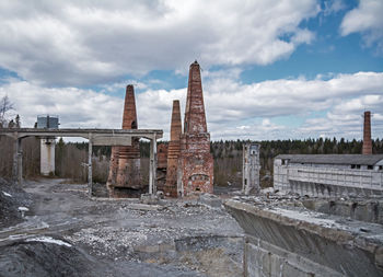 View of abandoned building against cloudy sky