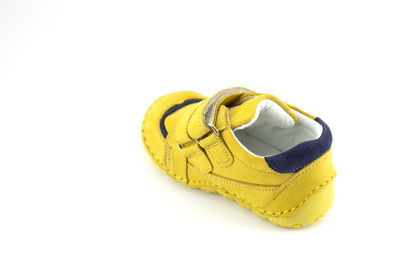 High angle view of yellow shoes over white background