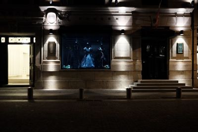 Illuminated railroad station in city at night