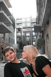 Portrait of friends against buildings in city