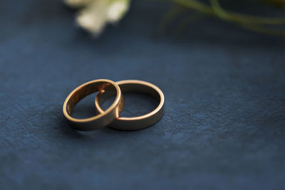 Studio shot of pair of golden wedding rings