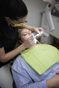 Female dentist with patient in office