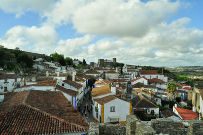 High angle shot of townscape against cloudy sky