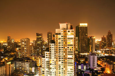 View of skyscrapers lit up at night