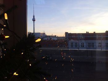 Buildings in city at sunset