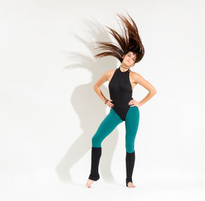 Full length of woman standing against white background