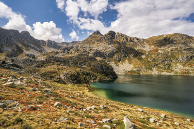 Scenic view of lake and mountains against sky