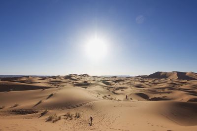 Scenic view of desert against sky on sunny day