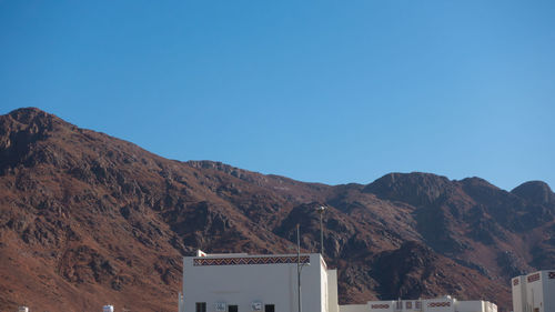 Scenic view of mountains against clear blue sky