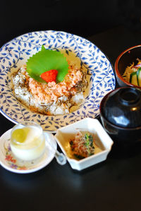 Close-up of food served on table against black background