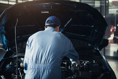 Rear view of man working