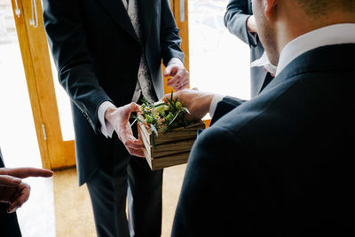 Midsection of businessmen having salads