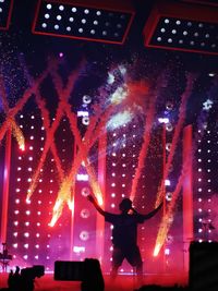 People photographing illuminated music concert