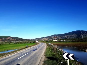 Empty road along countryside landscape